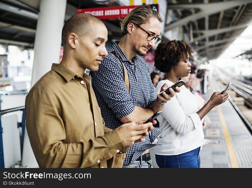 Three Person Holding Smartphones