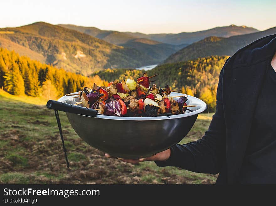 Person Holding a Bowl Full of Barbecue