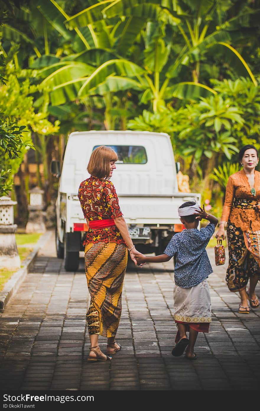 Woman Walking Holding Hand Boy