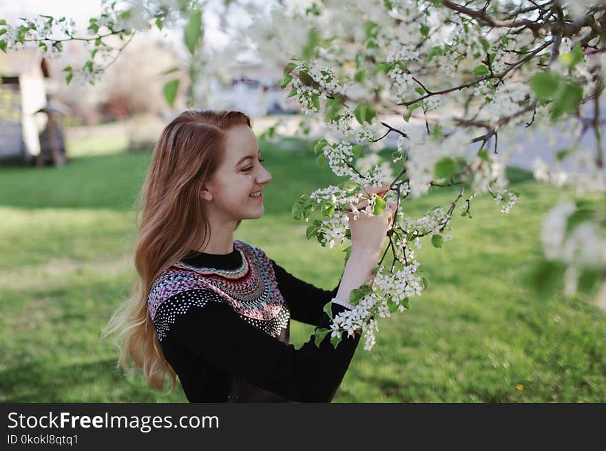 Woman In Black Sweater Holding Flowers