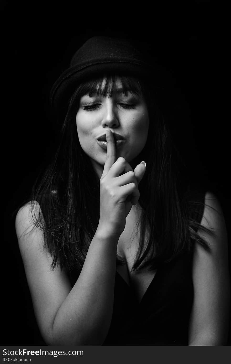 Monochrome Photography of Woman Doing Silent Gesture