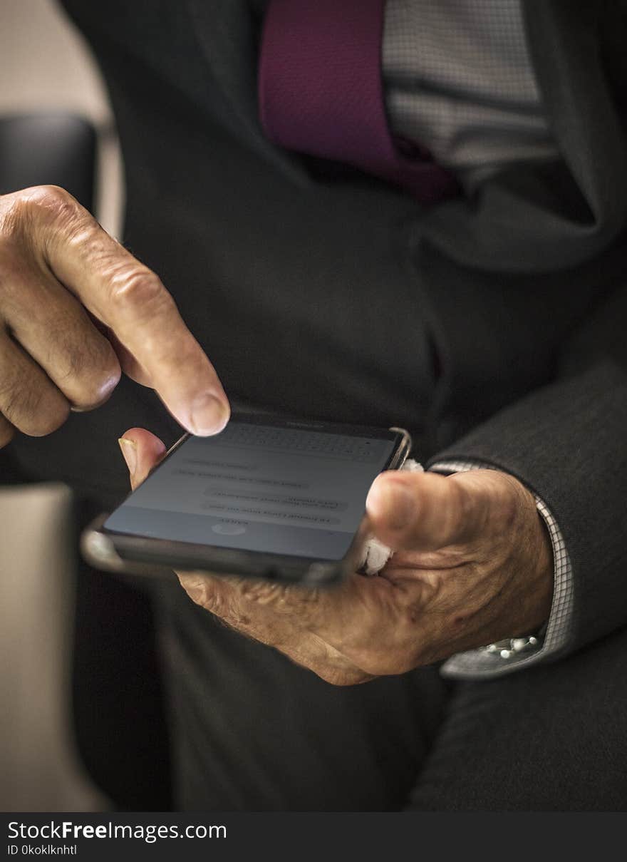 Person Holding Black Smartphone