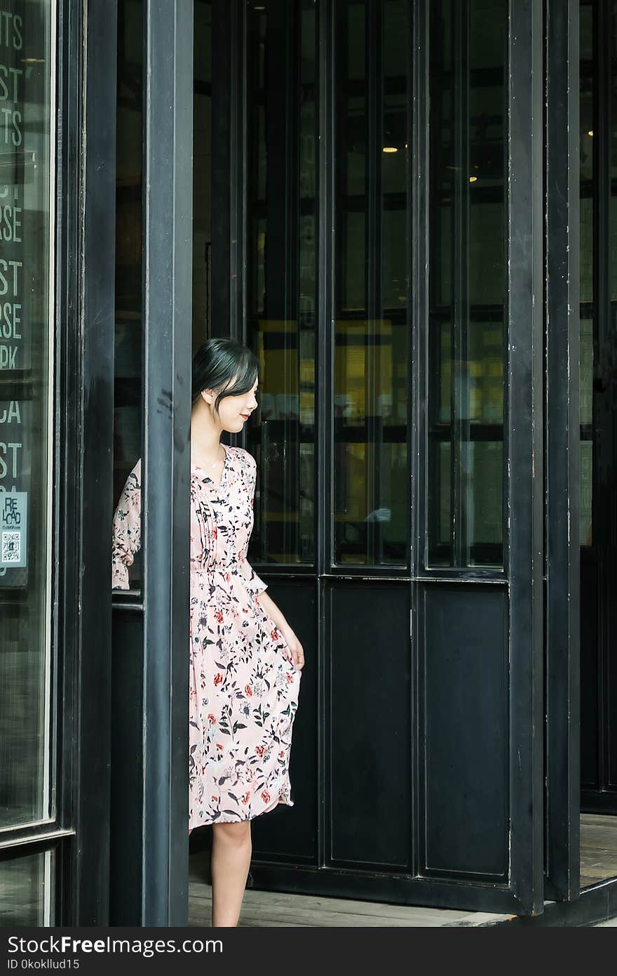 Black Haired Woman in Pink and Black Floral Dress