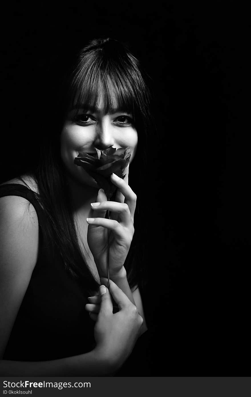 Grayscale Photo of Woman Holding Flower