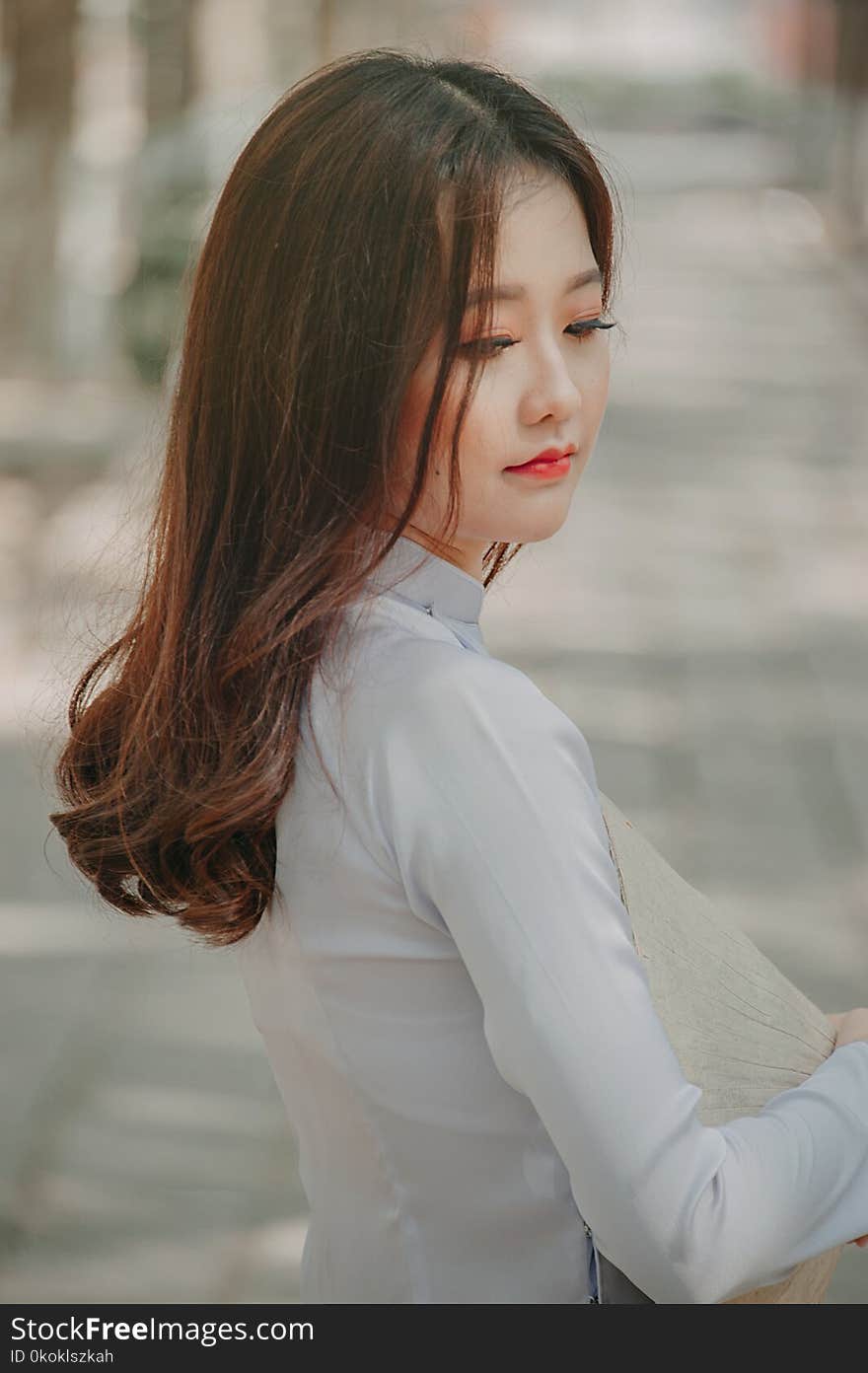 Close-up Photography of Woman in White Top