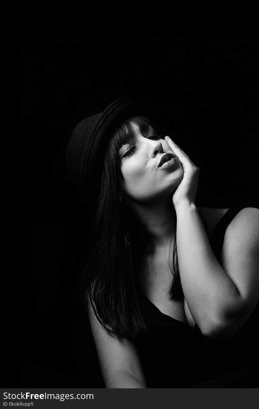 Grayscale Photography Of Woman In Tank Top Wearing Hat