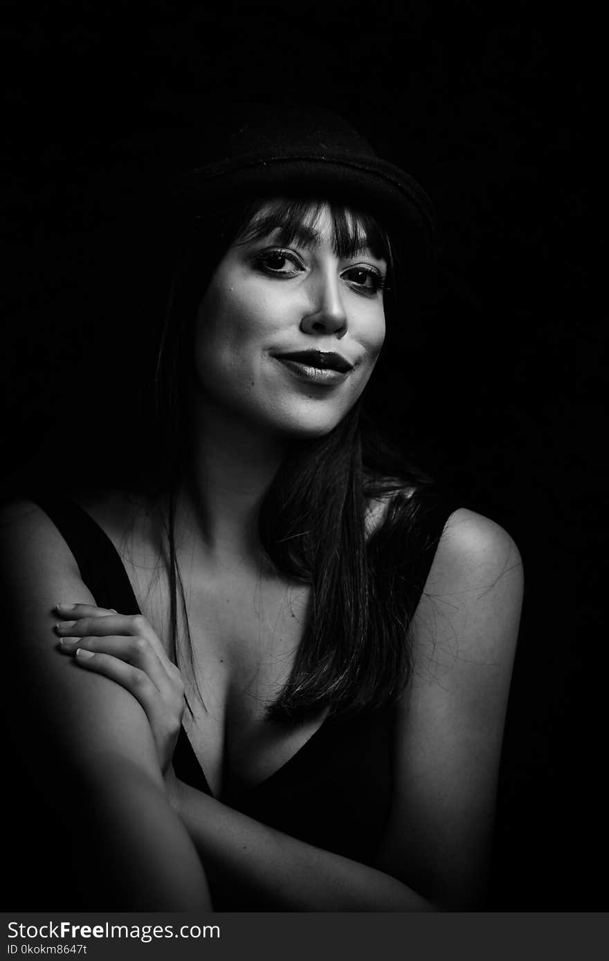 Greyscale Photo of Woman Wearing Tank Top and Hat