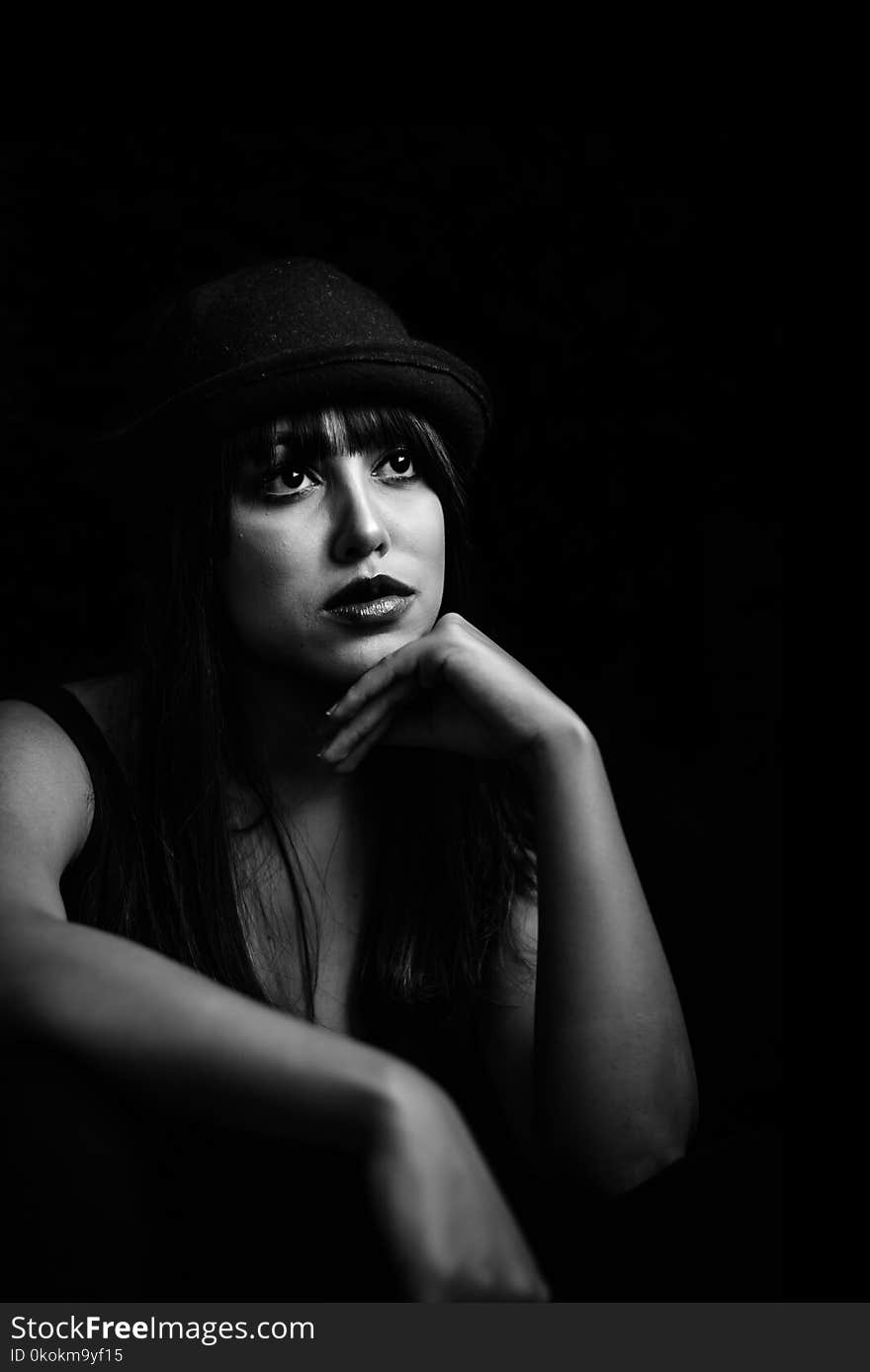 Grayscale Photo Of Woman Wearing Black Hat