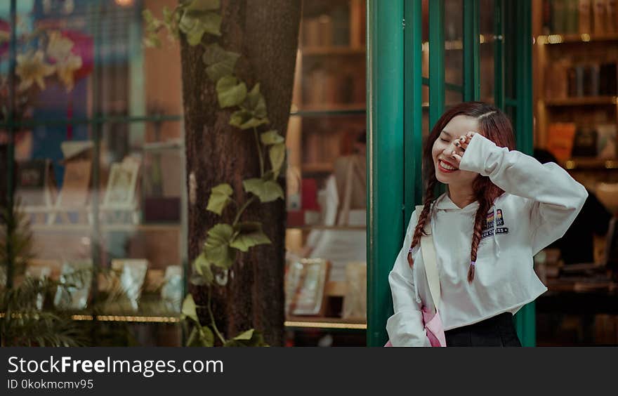 Photo of Woman Leaning on the Door