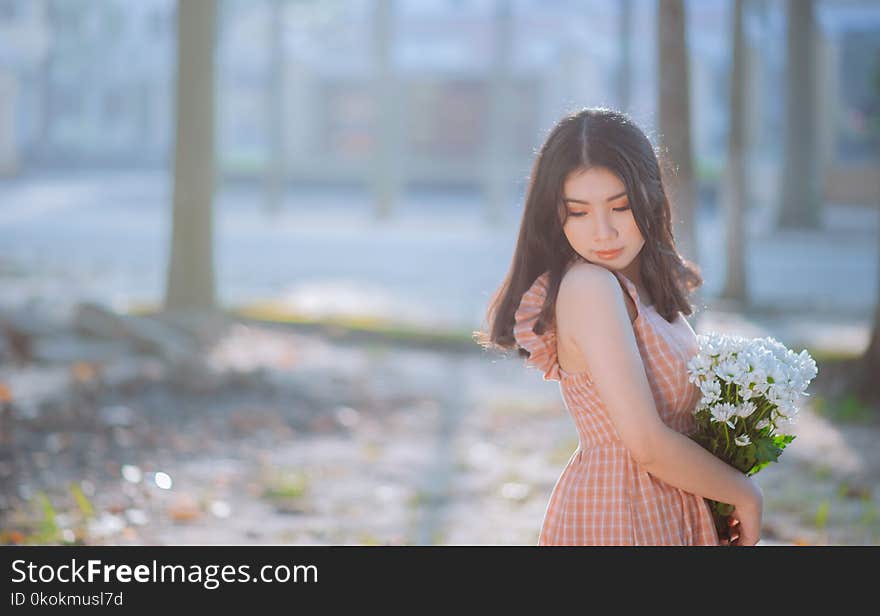 Photo of Woman Wearing Plaid Dress