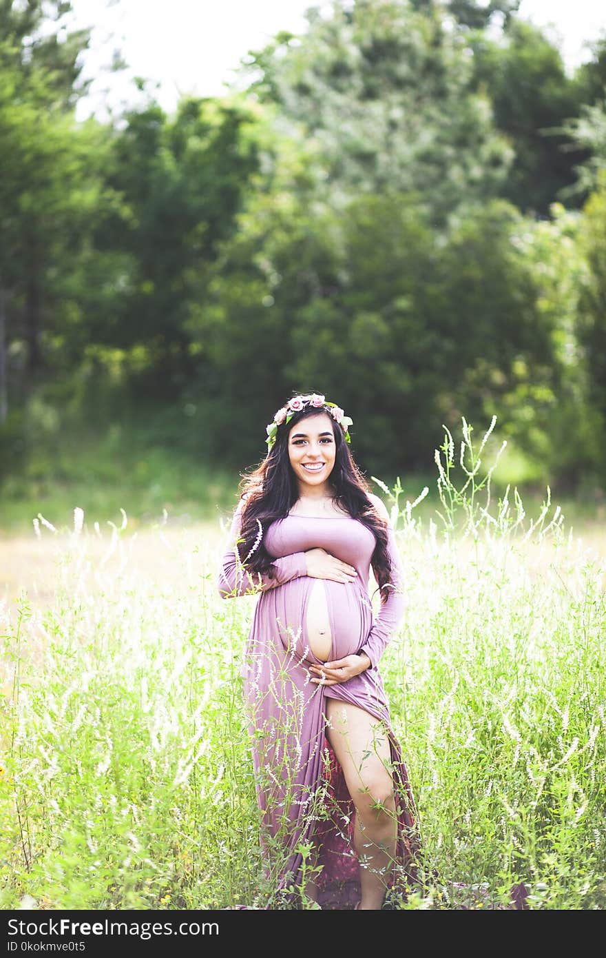 Photography of Pregnant Woman On Grass Field