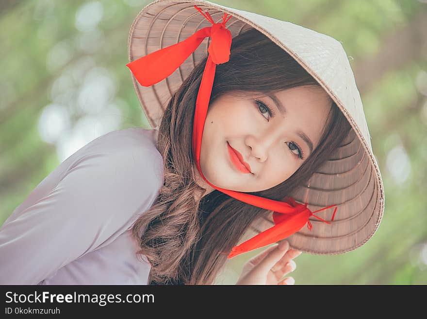 Close-Up Photography of a Woman Wearing Conical Hat