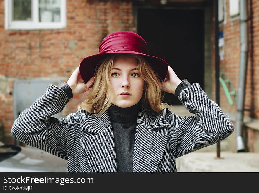 Close-Up Photography of a Woman Wearing Purple Hat