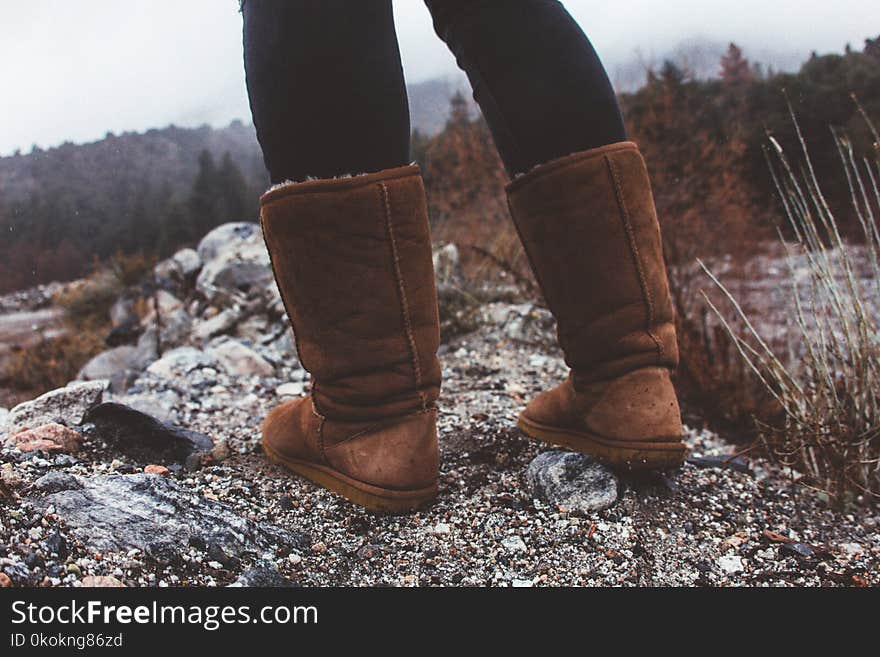 Close-Up Photography of a Person Wearing Brown Winter Boots