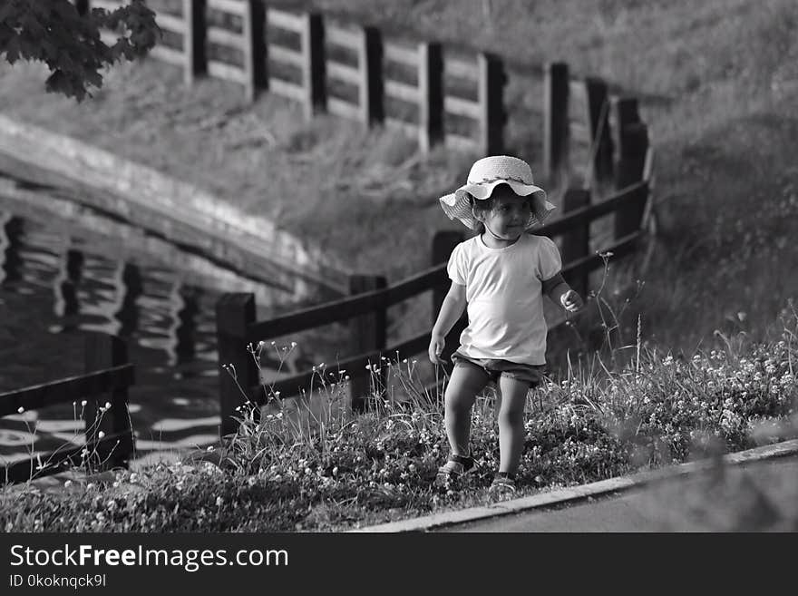 Monochrome Photography of Toddler On Flowers