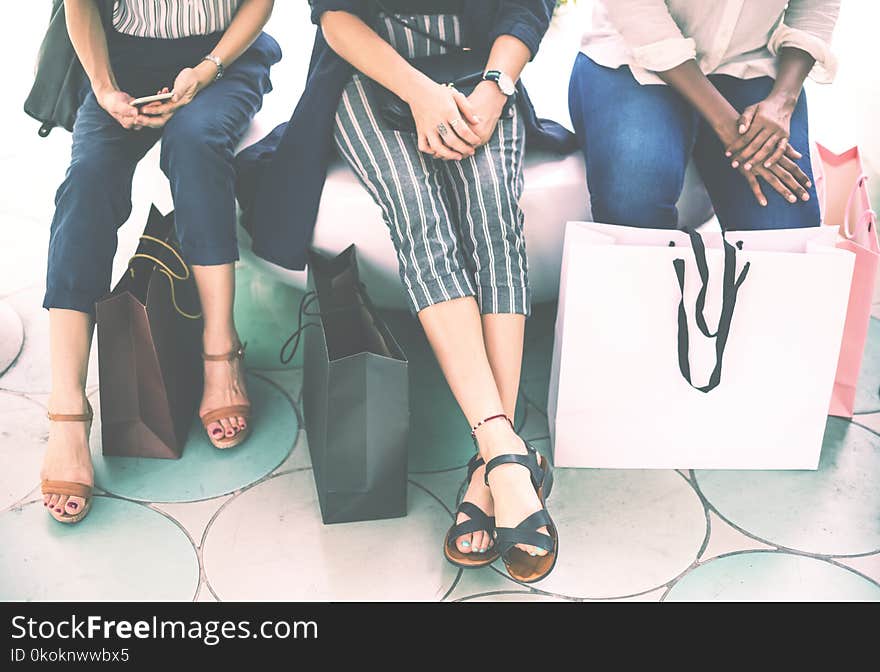 Three Woman Sitting on Chair