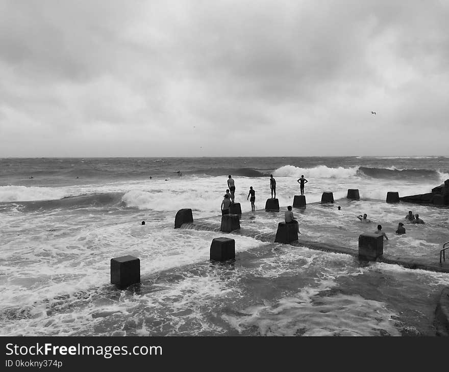 Grayscale Photo of People in Beach