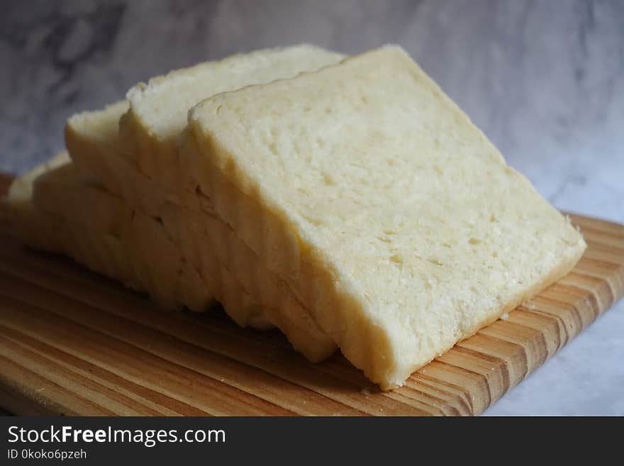 Photo of Sliced Bread on Brown Wooden Chopping Board