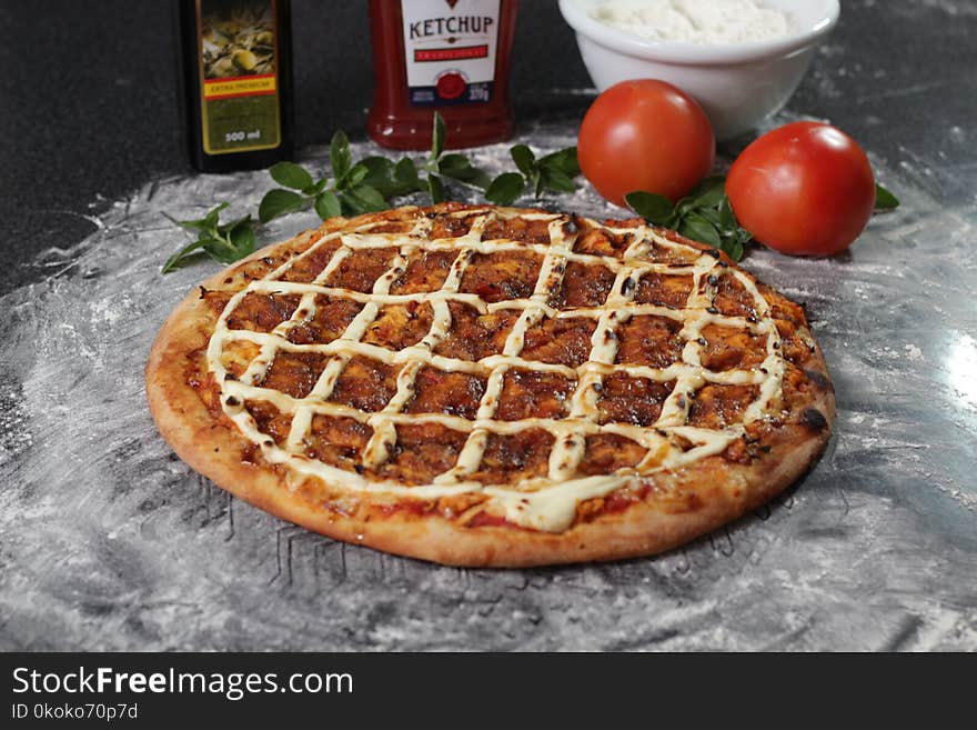 Baked Pizza Beside Two Red Tomatoes