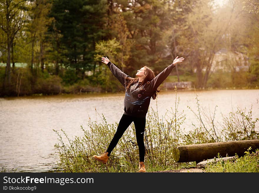 Photography of a Woman Near Lake