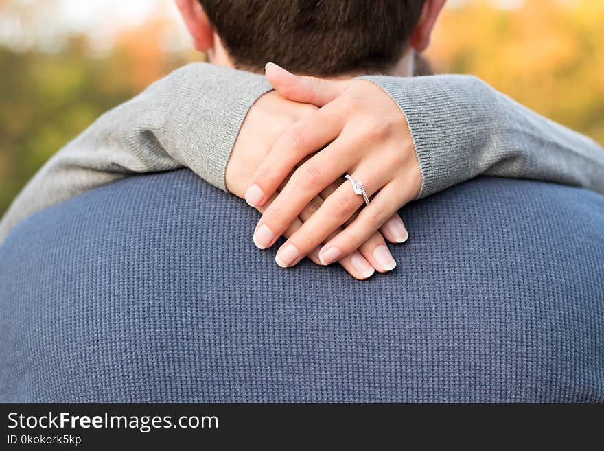 Woman Hand on Man&#x27;s Neck