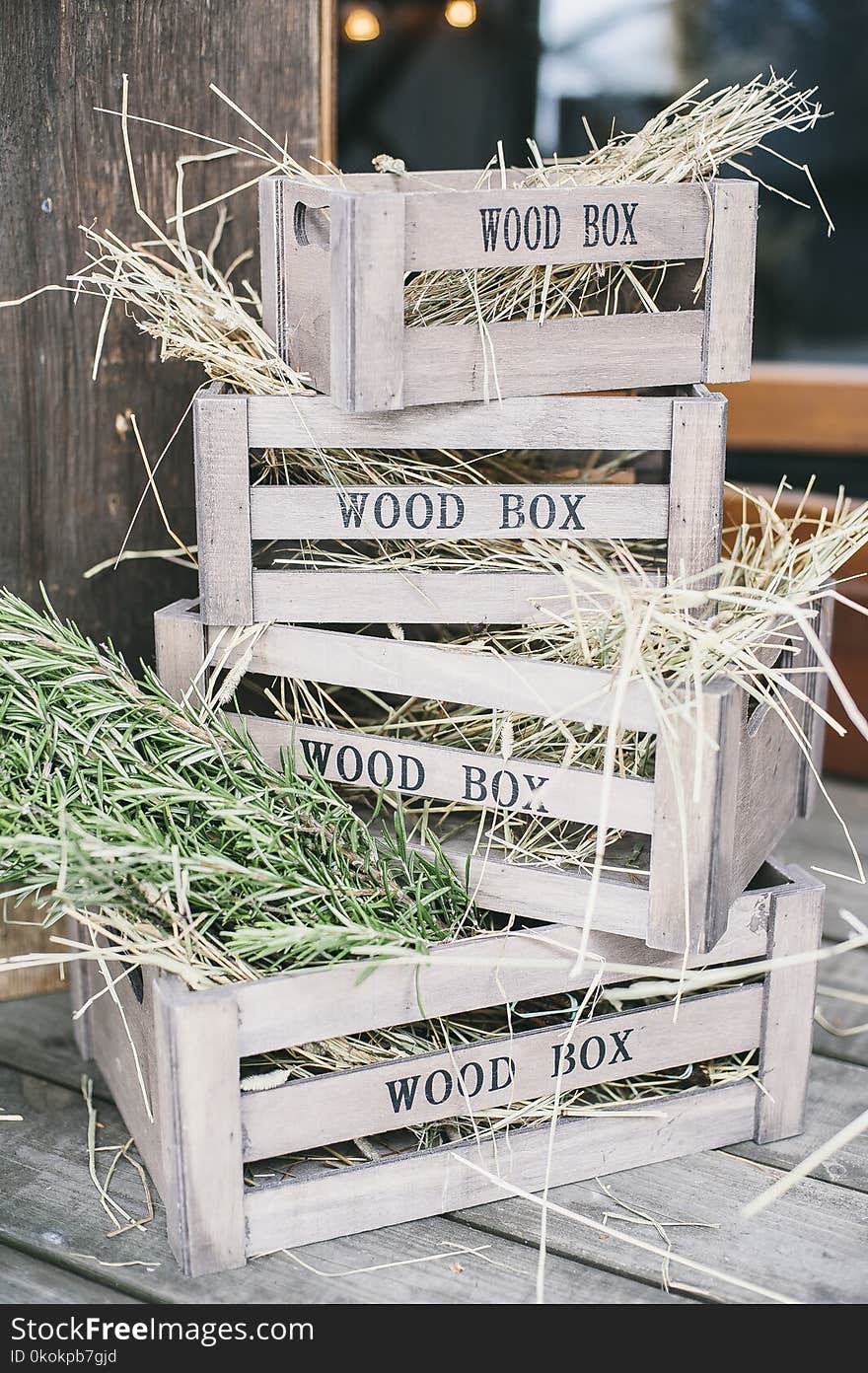 Four Stacks of Brown Wooden Crates With Hays