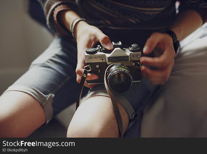 Person Holding Black and Gray Dslr Camera