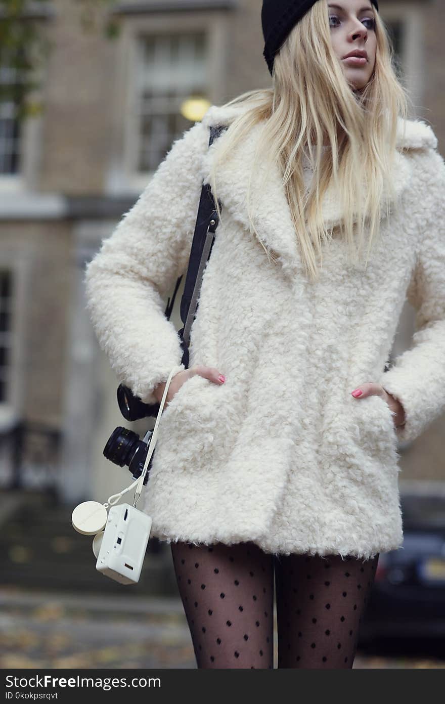 Woman Wearing White Coat Carrying Camera