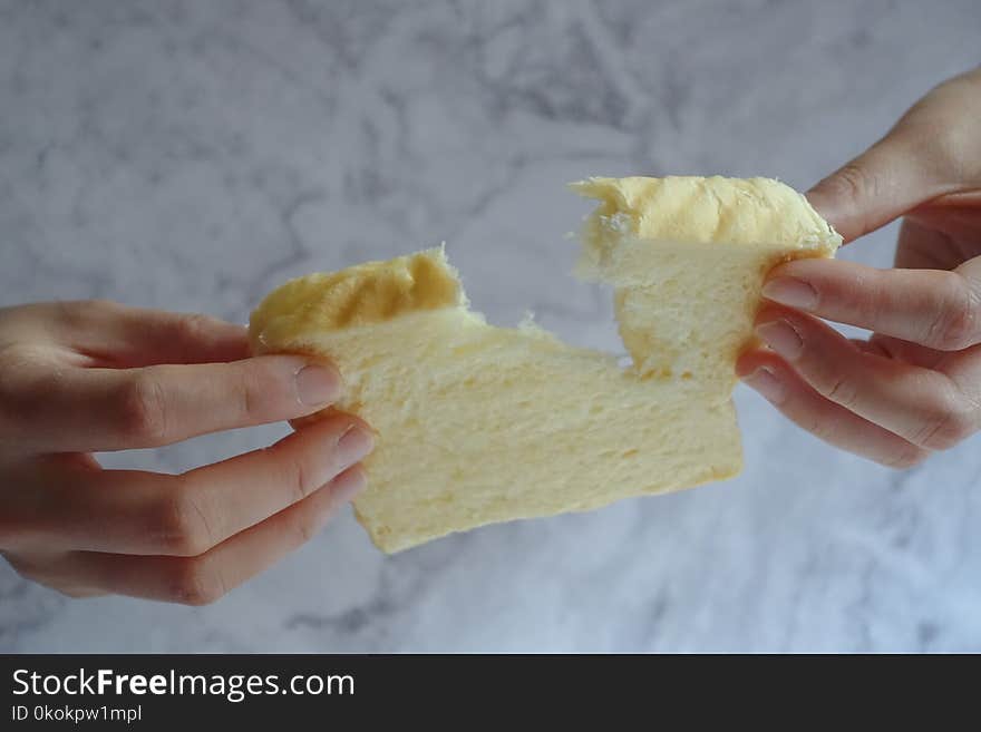 Person Holding Slice of Loaf Bread