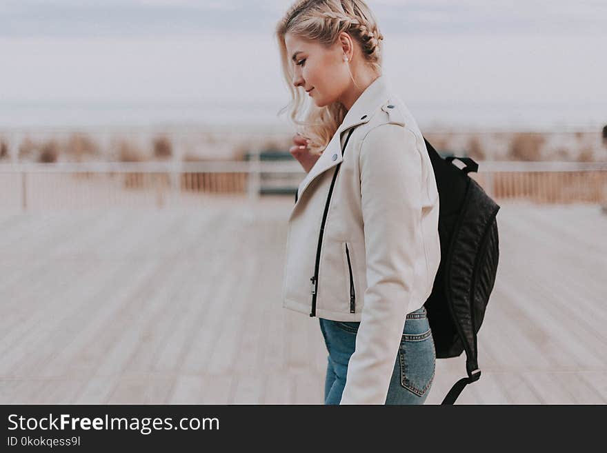 Woman in Black Zip-up Jacket With Black Backpack