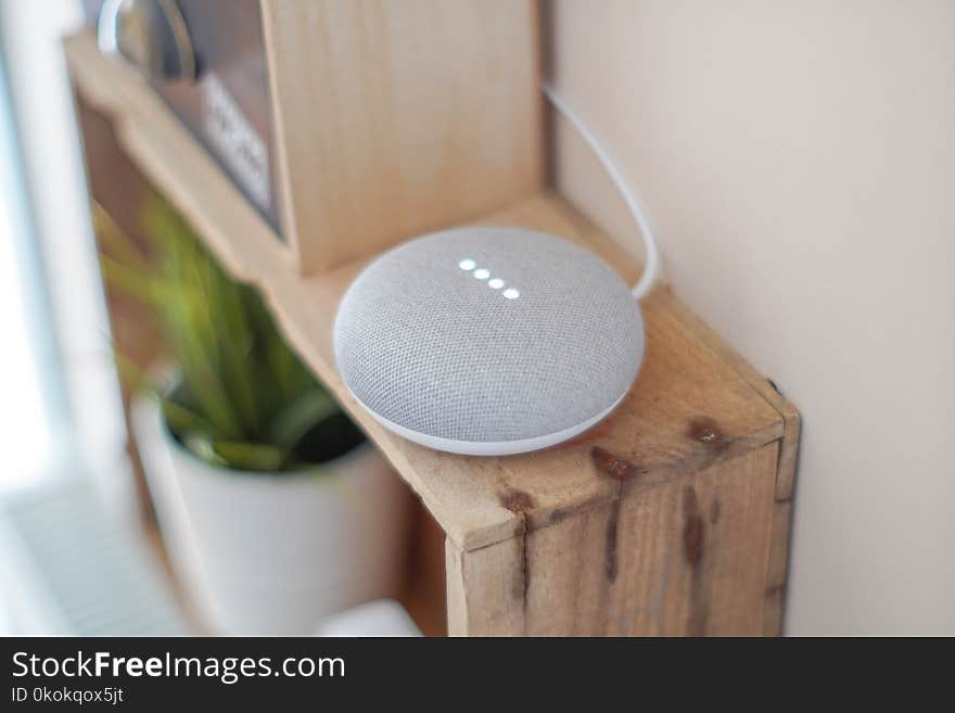 Round Grey Speaker On Brown Board