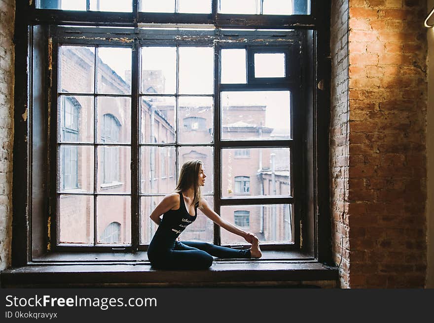 Woman Stretching Beside Window