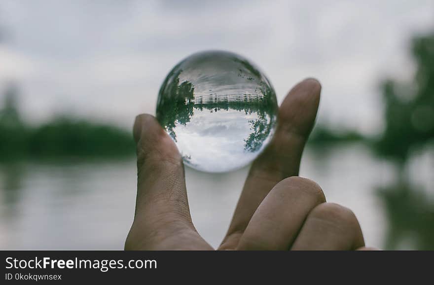 Close-Up Photography of Person Holding Crystal Ball