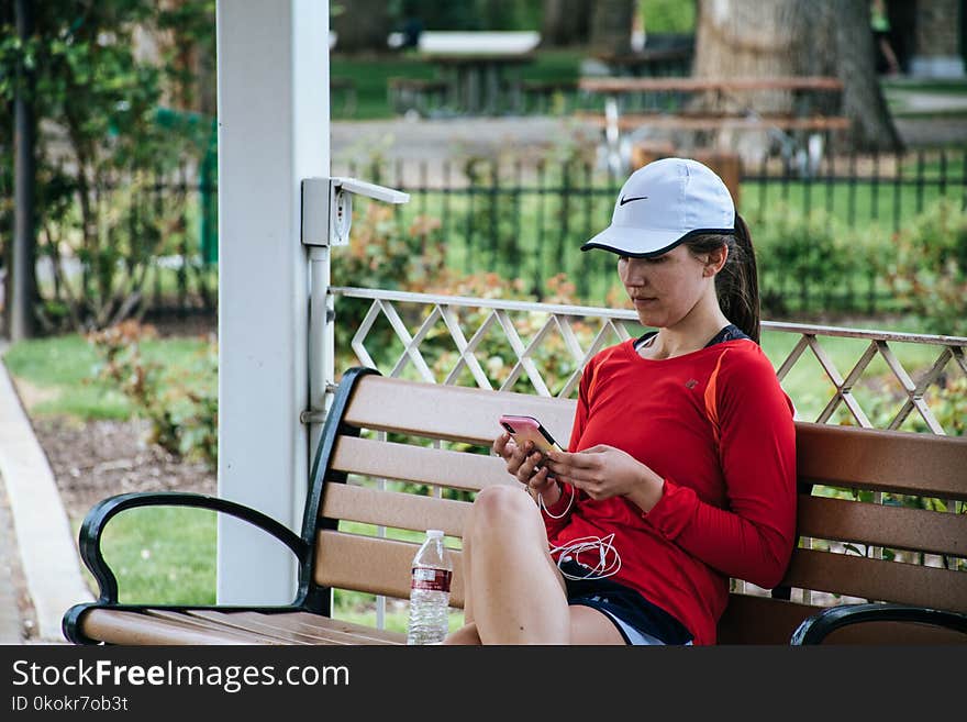 Woman In Red Long-sleeved Top Sitting On Bench