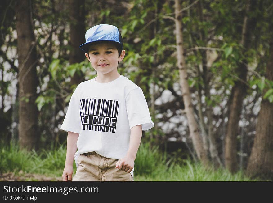 Boy In White Shirt And Blue Fitted Cap