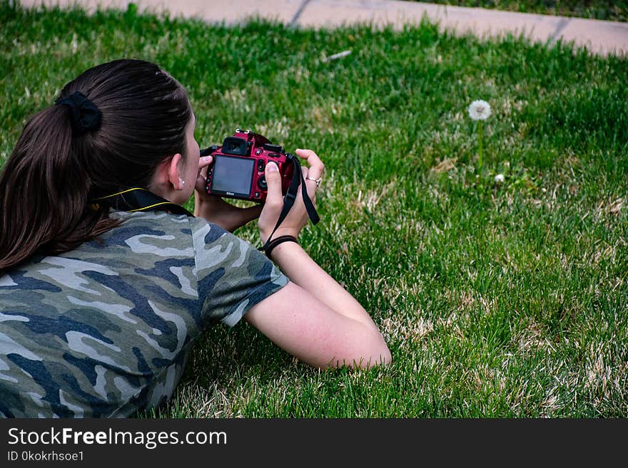 Woman in Camouflage T-shirt Holding Dslr Camera