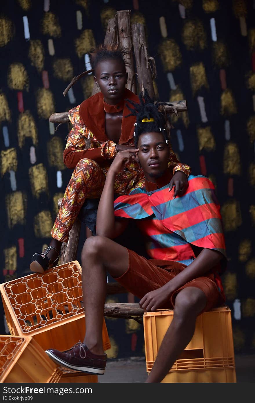 Couple Sitting and Standing on Crates for Photo