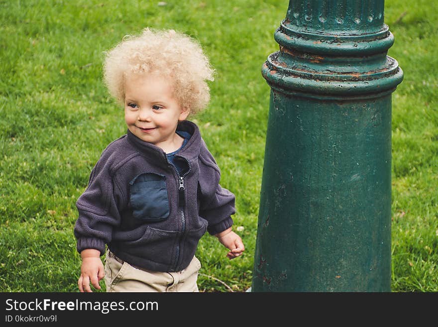 Toddler Wearing Jacket Beside the Light Post