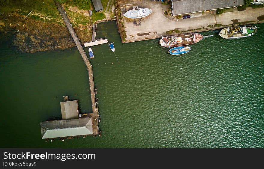 Bird&#x27;s Eye View of Boat Near Dock on Calm Body of Water