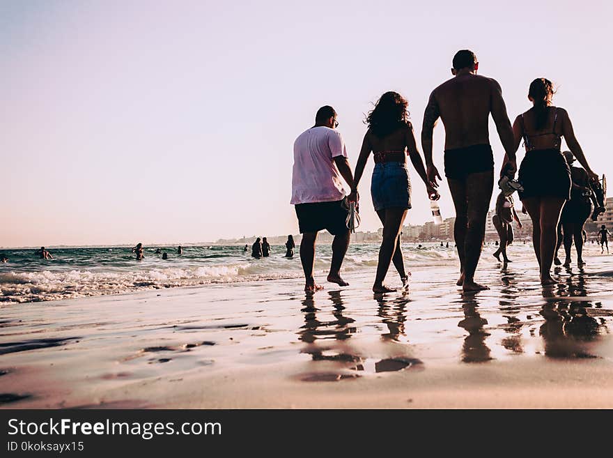 People Walking On Seashore