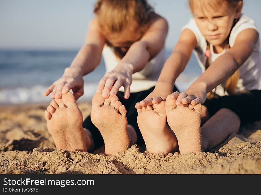 Happy family standing on the beach at the day time.