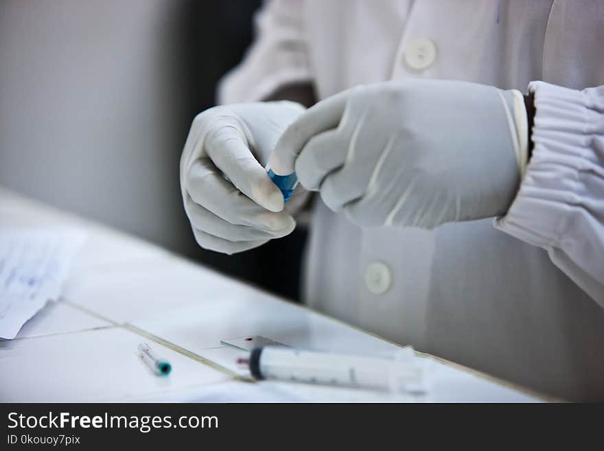 Hands of doctor holding blood test plates.