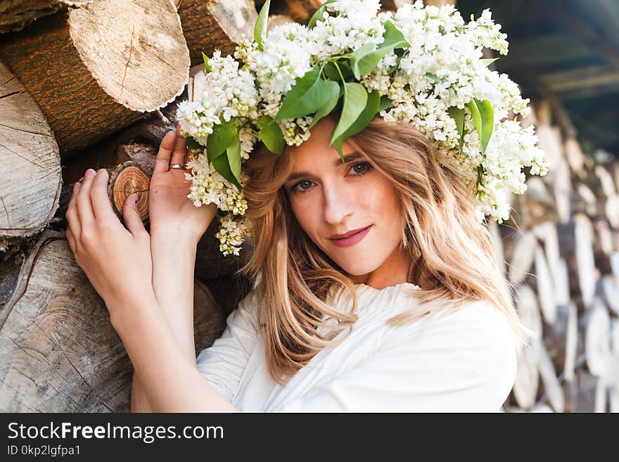 Portrait Of Young Woman In Lilac Wreath.