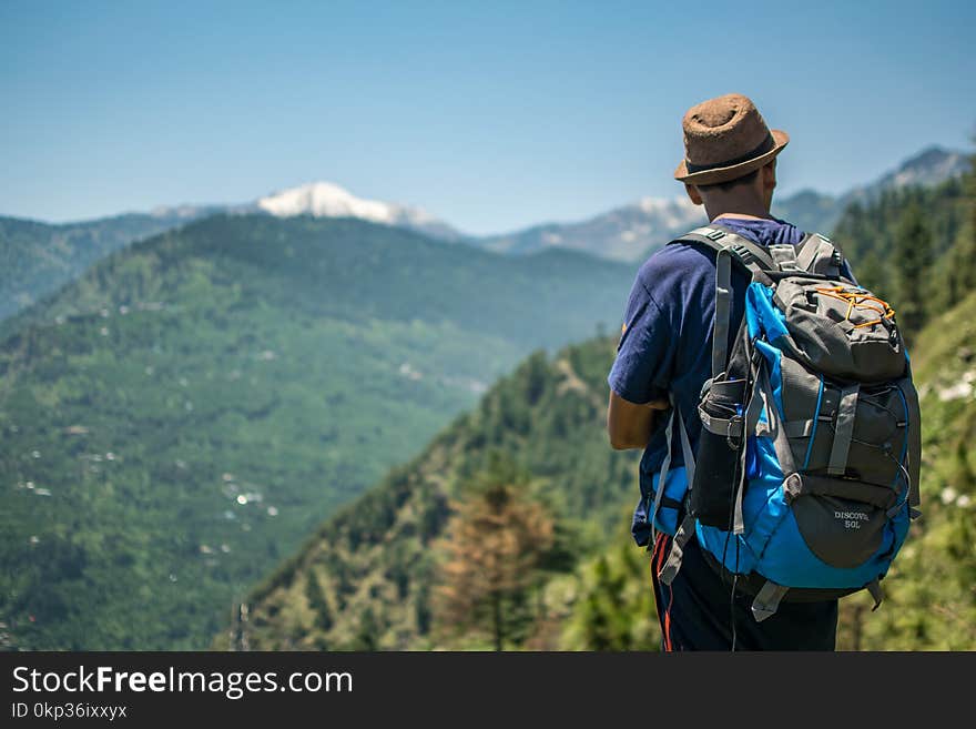 Selective Focus Photography of Man Carrying Hiking Pack