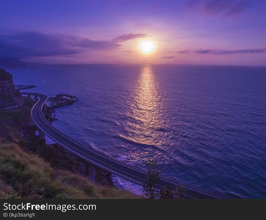 Body of Water Across Sunset