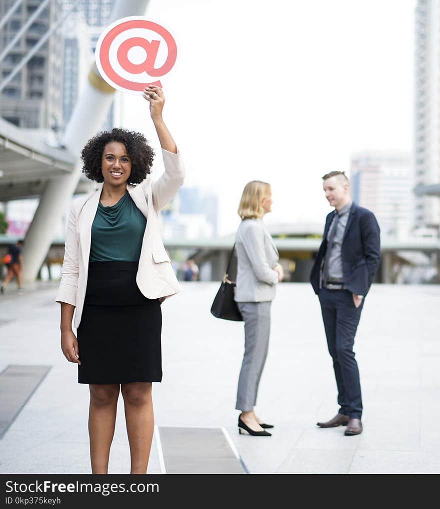 Woman Holding @ Sign