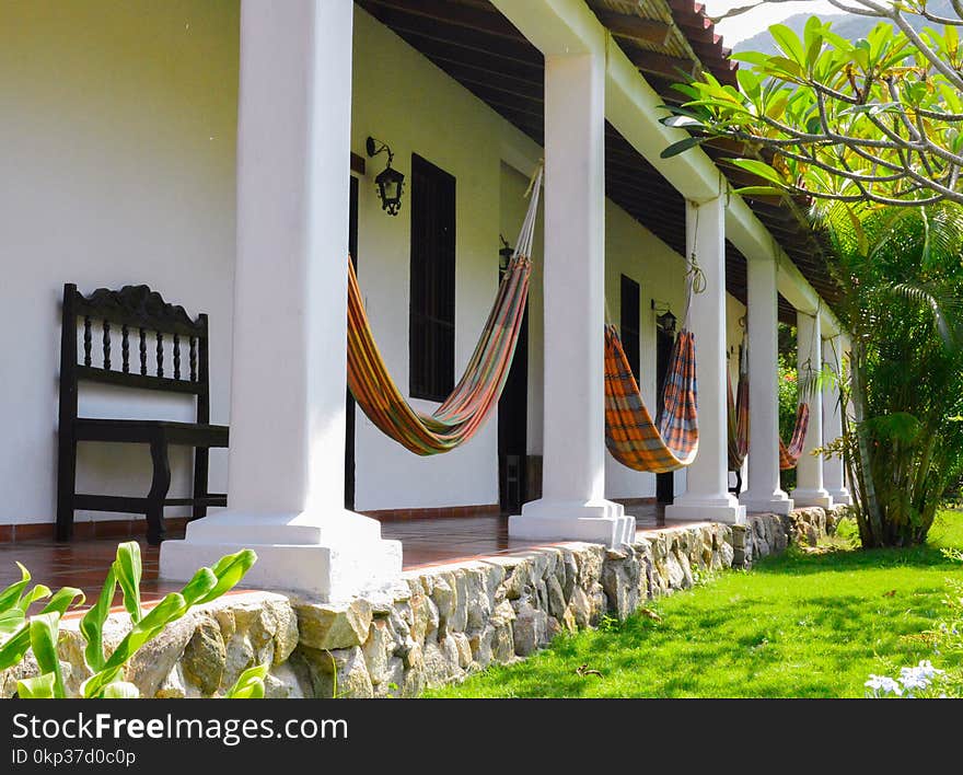 Several Orange Hammocks Hanged on White Concrete Posts