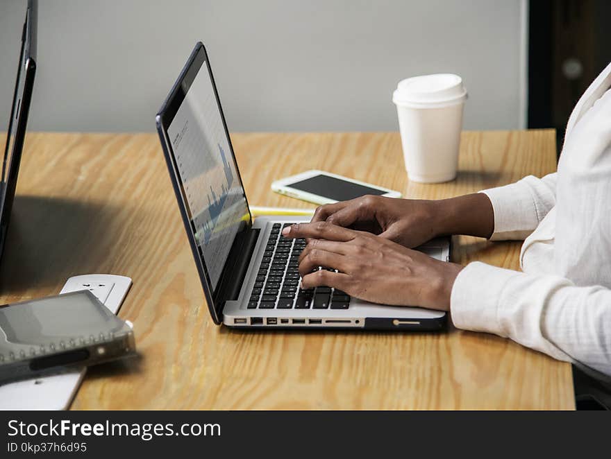 Person Wearing White Long-sleeved Top Using Laptop Computer