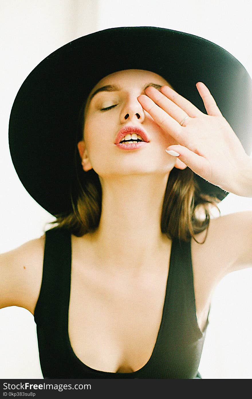 Photography of a Woman Wearing Black Scoop Neck Top