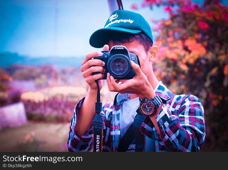 Shallow Focus Photography of a Man Holding Camera